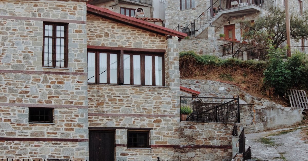 Stone houses and bell tower of traditional mountain village in Corfu