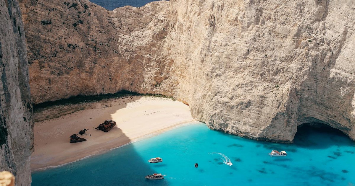 Small motorboat in a secluded turquoise Corfu cove