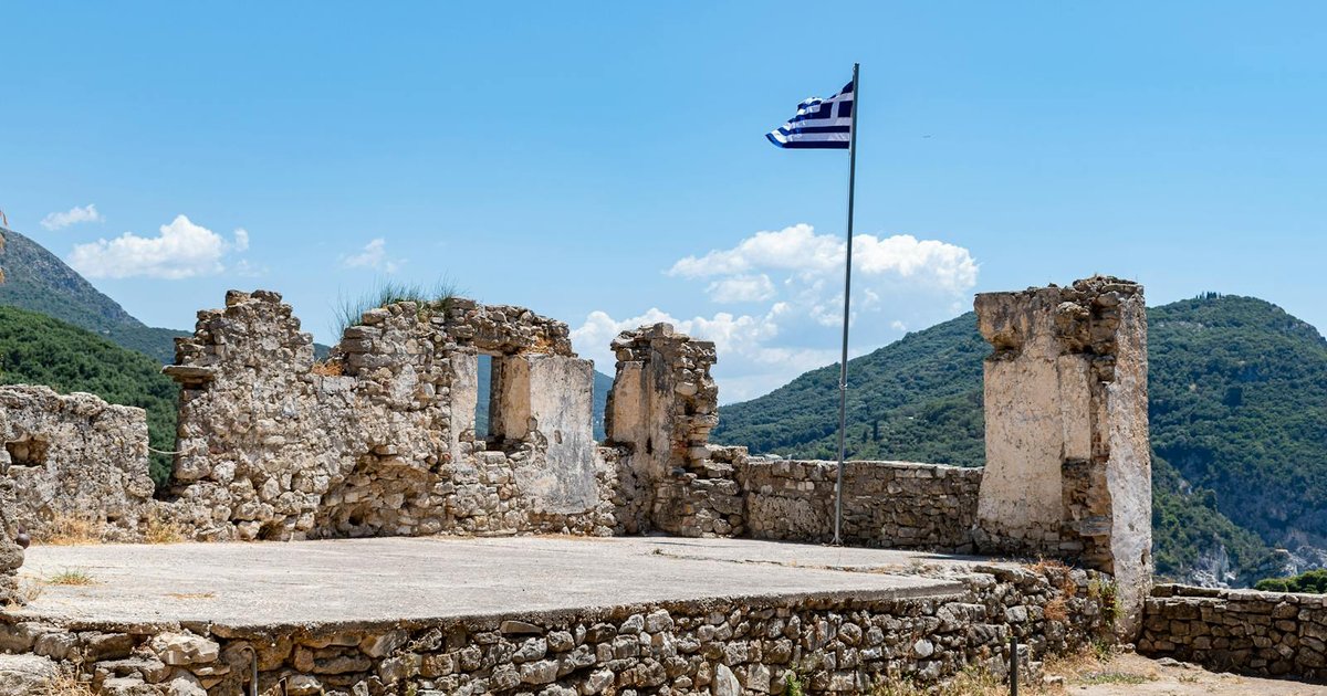Ancient stone ruins beneath olive trees in Corfu