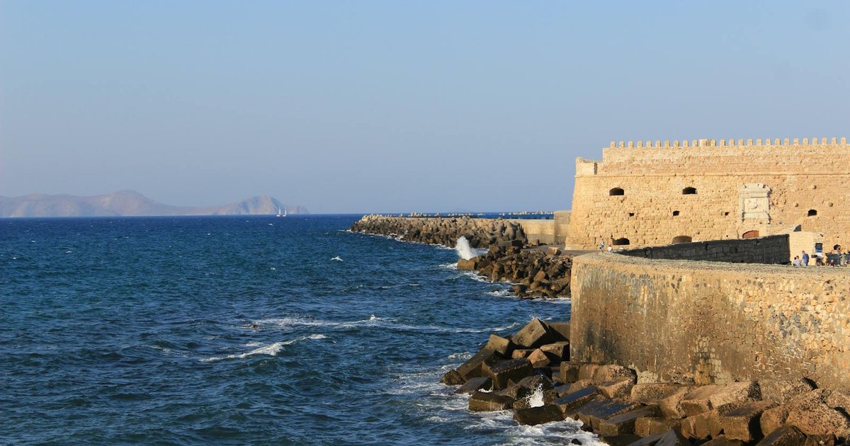The Old Fortress of Corfu rising from the sea at sunset